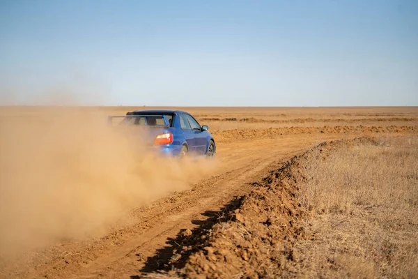 A rally sport car driving on the drit gravel race, fast speed with mud splash — Stock Photo, Image