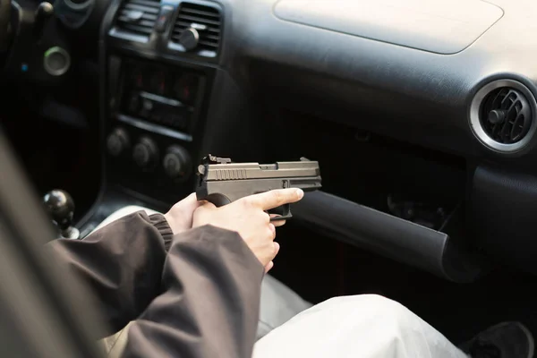 A crime concept, burglar taking the pistol and plannung a murder —  Fotos de Stock