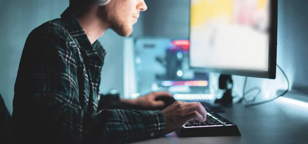 a male professional gamer take part in cyber sport championship, playing computer game