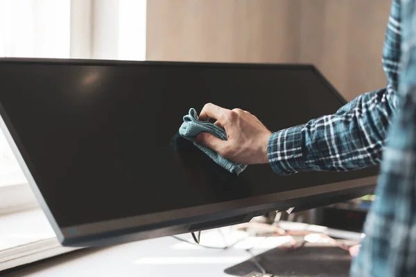 A hand holding a rag and wipe a digital monitor screen of device —  Fotos de Stock