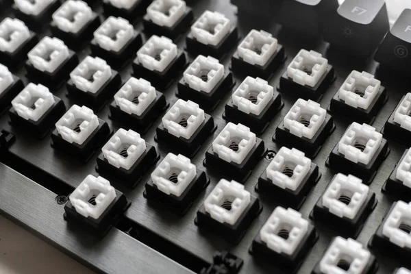 机の上の現代的なメカニカルキーボードスイッチ黒と白のキーキャップ — ストック写真