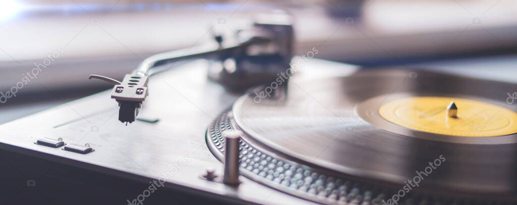 a macro close up record player needle playing the vinyl disc, old fashioned retro music player