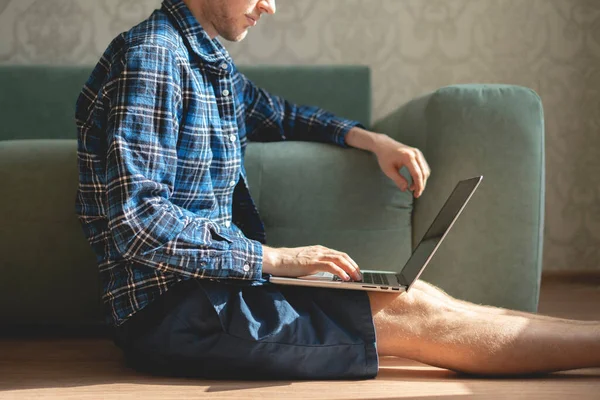 La vista aérea superior de la persona masculina tendida en el suelo y trabajando en el ordenador portátil durante la pandemia covid-19, trabajo a distancia en línea — Foto de Stock