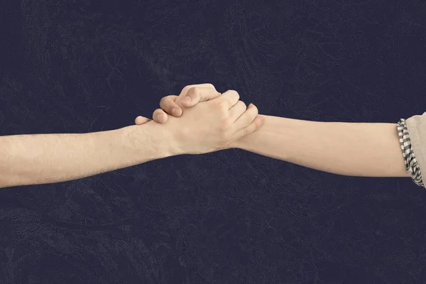 The two hands support each other, handshake, isolated against the colorful background — Stock Photo, Image