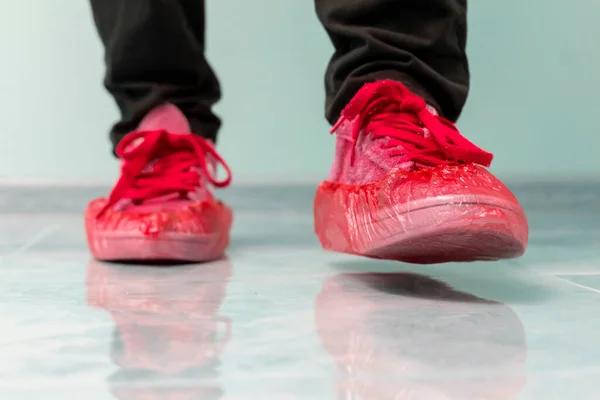 Um paciente do hospital visitante andando no sapato cobre para proteger a higiene no chão — Fotografia de Stock