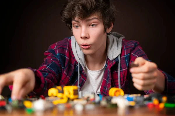 Joven macho construir juguete ladrillos en madera mesa niño juguete infancia b —  Fotos de Stock