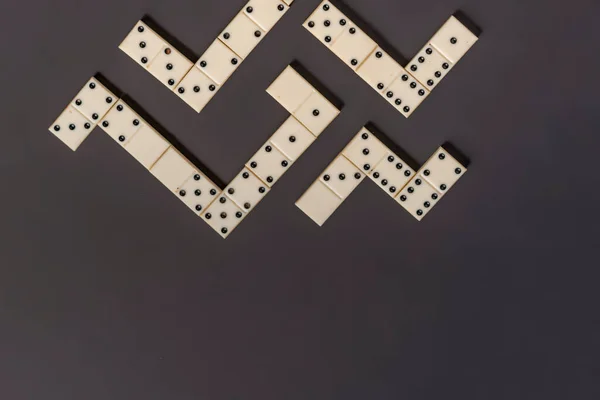 Bright domino lay on dark background in line isolated g — Stock Photo, Image