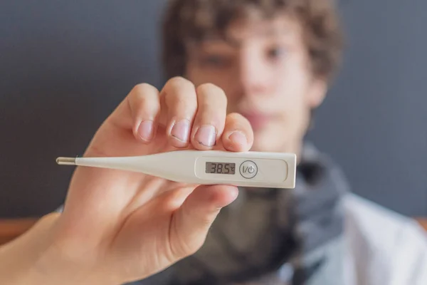 Sad teenager lay in bed and hold thermometer. illness concept b — Stock Photo, Image