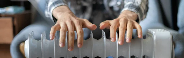 Feeling cold, getting warm, hands touching heater close up — Stock Photo, Image