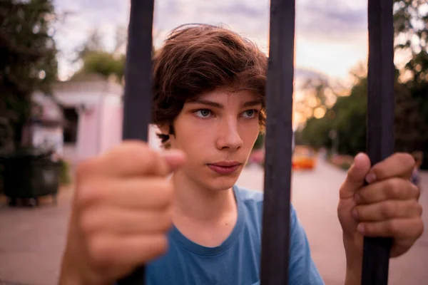 Close up dispair man standing next to the cell looking at the city freedom life — Stock Photo, Image