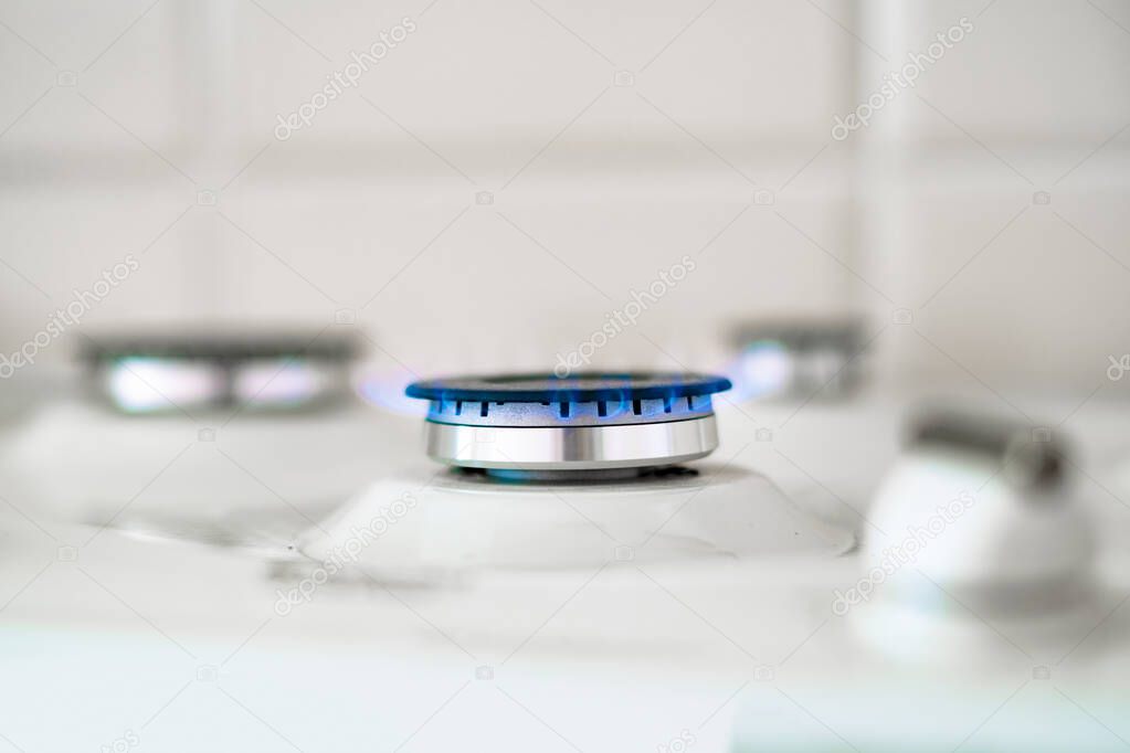 close up macro shot of birning gas ring on light background, natural resources concept