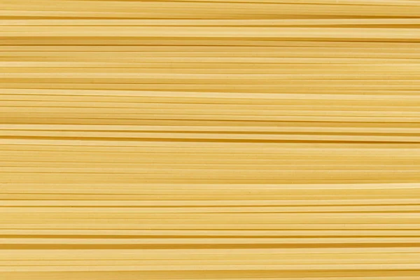 Abstraktní podklad se syrovou nebo tepelně neupravenou texturou špaget, kopírovací prostor pro text — Stock fotografie