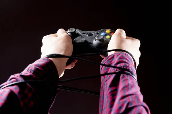 Joystick wire wrapped around persons hands, video games addiction concept b — Stock Photo, Image