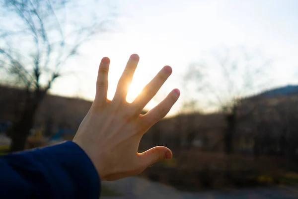 First person view of persons hands cover sun b — Stock Photo, Image