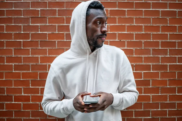 Front Shot African Man Serious Gesture Hood Using Smartphone City — Stockfoto