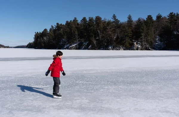 Young Boy Ice Skating Frozen Lake Winter Day Canada — Stock Photo, Image