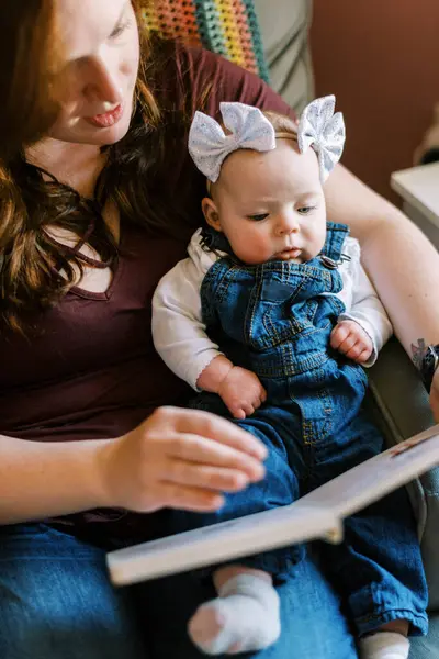 Young Mother Reading Her Baby Book Nursery Rocking Chair — Stock Photo, Image