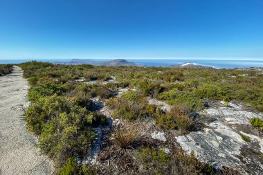 Panoramic view from summit top of Table Mountain to Cape of Good Hope peninsula, Cape Town, South Africa in the morning against blue sky