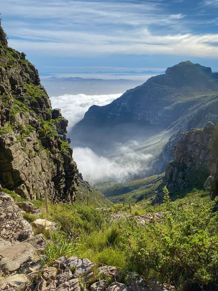 View from top of Platteklip George hiking trail at Table Mountain to upcoming clouds over Cape Town in the morning
