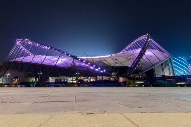 Doha, Qatar  October 1, 2019: Colorful illuminated Khalifa International Stadium in Doha at night, Qatar, Middle East against dark clear sky.