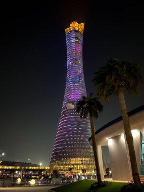 Doha, Qatar  September 29, 2019: The illuminated Torch Tower in Doha Sport City Complex at night against dark sky.