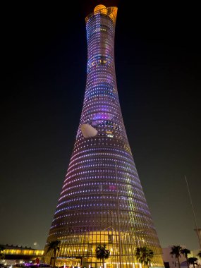 Doha, Qatar  September 29, 2019: The illuminated Torch Tower in Doha Sport City Complex at night against dark sky.