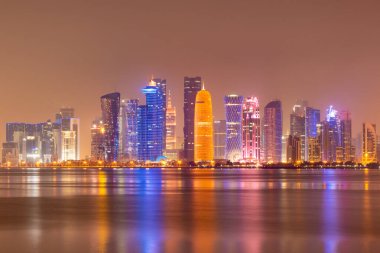 Coloful illuminated skyline of Doha at night, Qatar, Middle East against dark sky