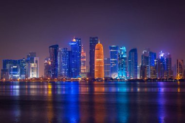 Coloful illuminated skyline of Doha at night, Qatar, Middle East against dark sky