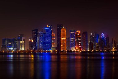 Coloful illuminated skyline of Doha at night, Qatar, Middle East against dark sky