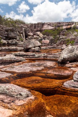 Güzel doğal portakal suyu şelalesi ve kayalık arazide nehir.
