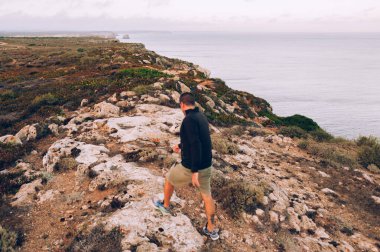 Dağın yamacında duran adam