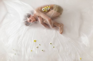 Plastik torba içindeki çıplak insanların stüdyo portresi, plastik kirlilik konsepti