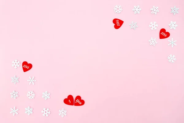 バレンタインデーの背景 ピンクの背景に赤いハートと雪の結晶 バレンタインデーのコンセプト フラットレイアウト トップビュー コピースペース — ストック写真