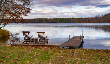 autumn. beautiful landscape with chairs near  calm lake