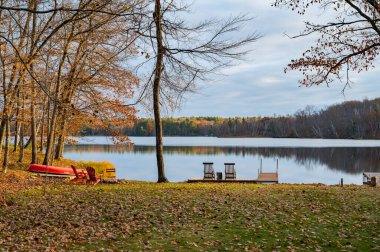 autumn. beautiful landscape with chairs near  calm lake
