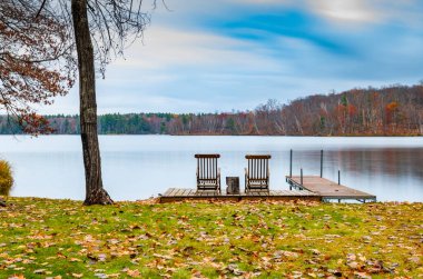 autumn. beautiful landscape with chairs near  calm lake