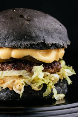 Siyah arka planda Amerikan yapımı sulu hamburger.