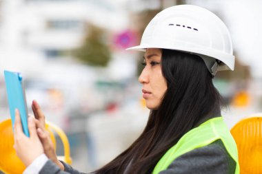 Professional industrial engineer use tablet computer at construction field 