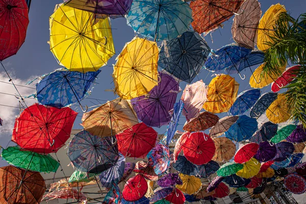 Colored umbrellas suspended in the air in higuey