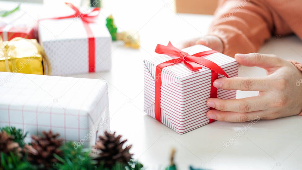 Closeup female hands holding gift box. Christmas Birthday and Happy New Year concept.