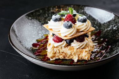 desenli siyah arkaplanda meyve ve çikolata tatlısı