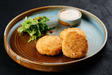 Siyah arka planda soslu ızgara somon pirzolası.