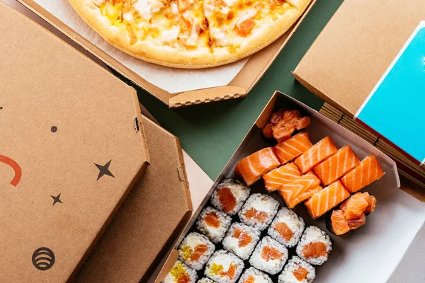 Set of delivery food. pizza sushi rolls
