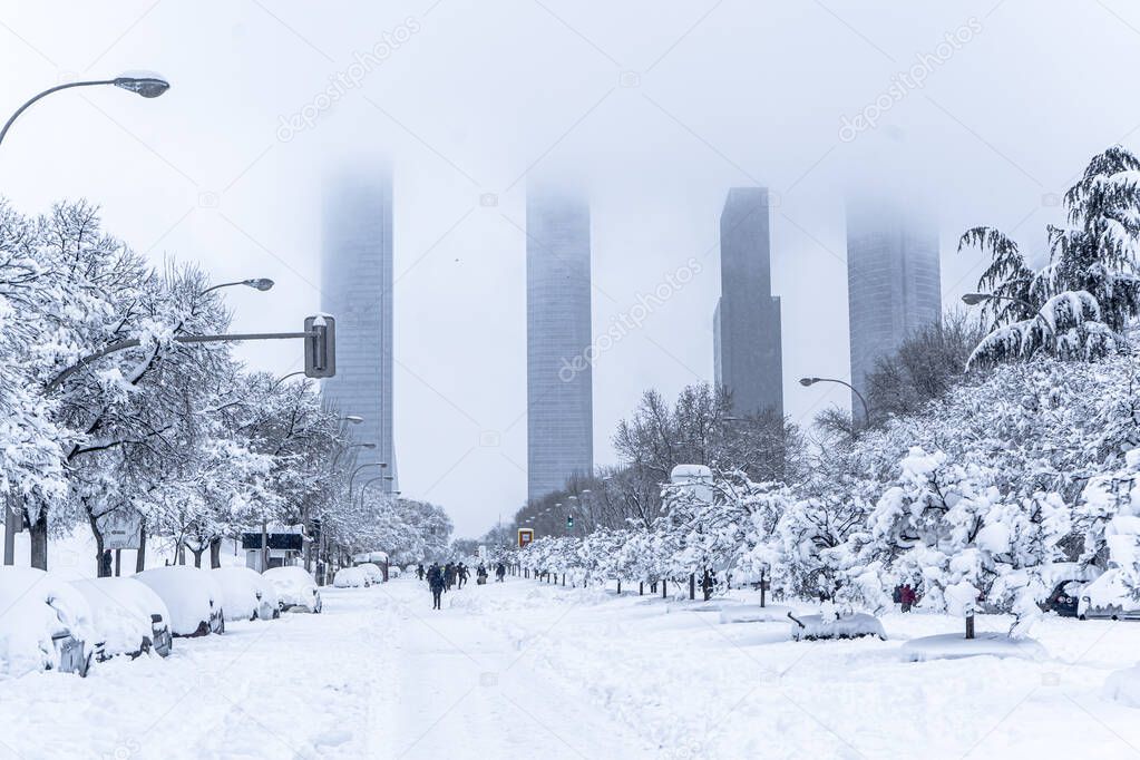 A view in winter of the Madrid four towers, view from a snowy park.