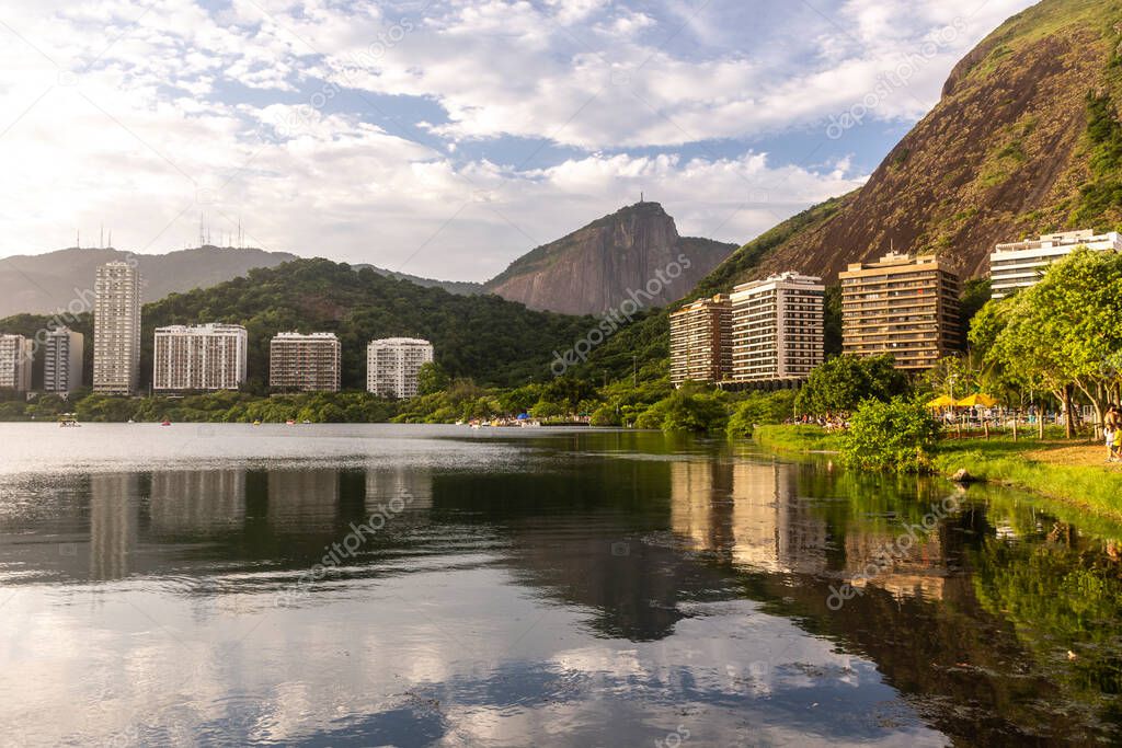 Beautiful view to buildings, city lake and Corcovado Mountain in Rio de Janeiro, Brazil