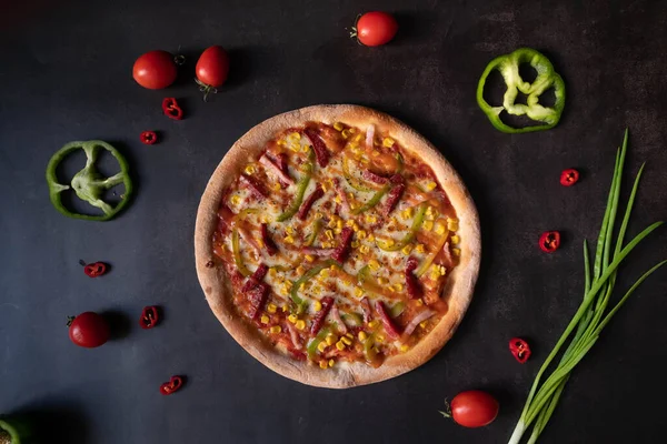 Mexican pizza with peppers and corn  on  dark background