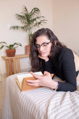 Young woman studying in bedroom