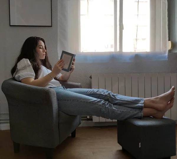 Young Woman Reading Book Armchair — Zdjęcie stockowe