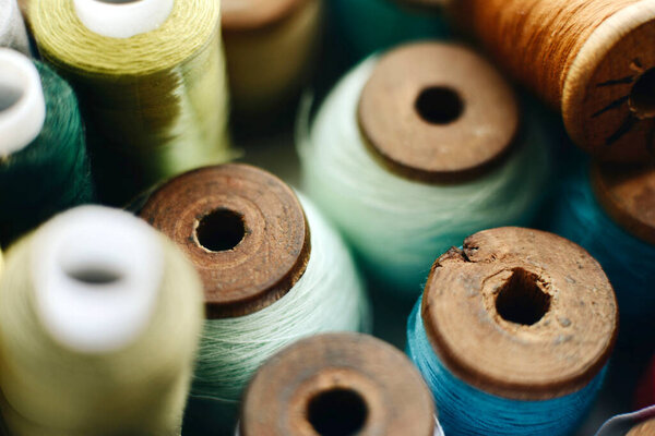 colorful threads spools for sewing in shop, close up
