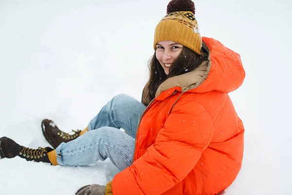 Young Woman Orange Jacket Laying Snow Winter — Stock Photo, Image